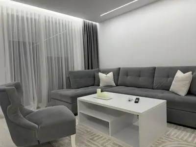 a living room with a couch and a chair at Apartman welsh in Bugojno