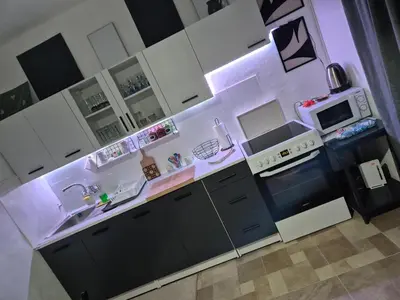 a kitchen with white cabinets and a stove top oven at Apartman Una Vista in Ivišovo Greblje