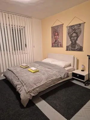 a bedroom with a bed with two towels on it at Apartman Una Vista in Ivišovo Greblje