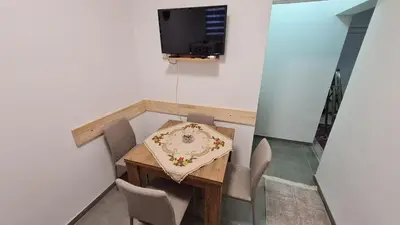 a small dining room with a table and chairs at Sabina apartmani in Tuzla