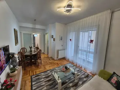 a living room with a table and a couch at Urban BL in Banja Luka
