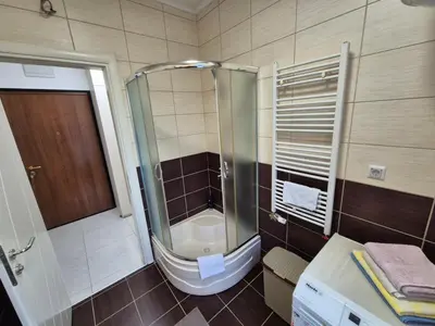 a bathroom with a shower with a toilet and a sink at Urban BL in Banja Luka