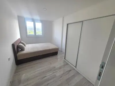 a bedroom with a bed and a sliding glass door at Dora in Bugojno