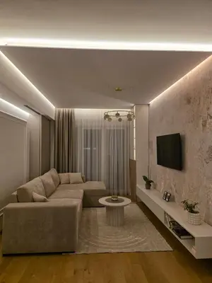 a living room with a couch and a tv at Palace Residence Apartment in Banja Luka