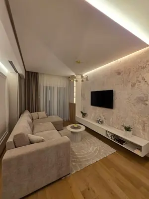 a living room with a couch and a flat screen tv at Palace Residence Apartment in Banja Luka