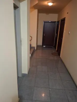 a hallway of an apartment with a tile floor at Studio apartman in Banja Luka