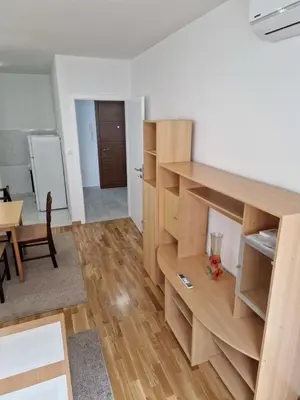 a living room with wooden shelves and a table at Ada flat in Banja Luka