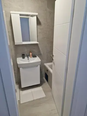 a bathroom with a white sink and a mirror at Ada flat in Banja Luka