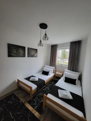 a room with two beds and a window at KRUNA Apartment in Cazin