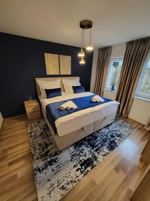 a bedroom with a bed with two towels on it at KRUNA Apartment in Cazin