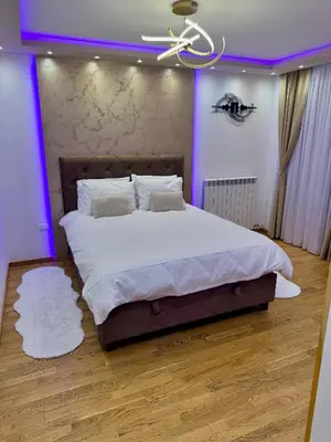 a bedroom with a large bed with purple lighting at Jelena Apartments in Banja Luka