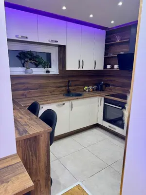 a kitchen with white cabinets and a sink at Jelena Apartments in Banja Luka