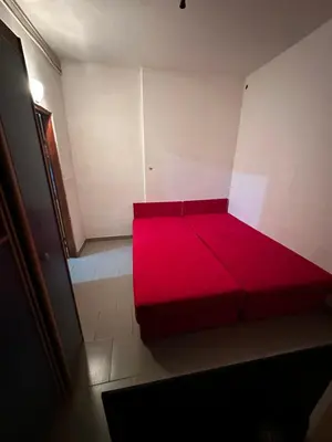 a red couch sitting in the corner of a room at Veliko Brdo BL in Banja Luka