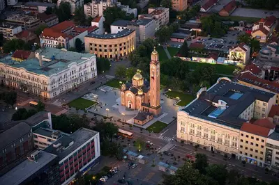 an aerial view of a city with a clock tower at Veliko Brdo BL in Banja Luka