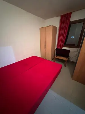 a red bed in a room with a cabinet at Veliko Brdo BL in Banja Luka