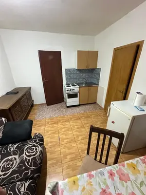 a kitchen with a couch and a stove in a room at Veliko Brdo BL in Banja Luka