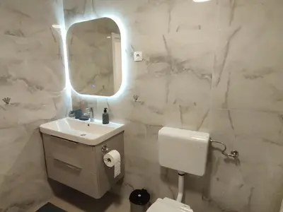 a white bathroom with a sink and a mirror at Old Town in Livno