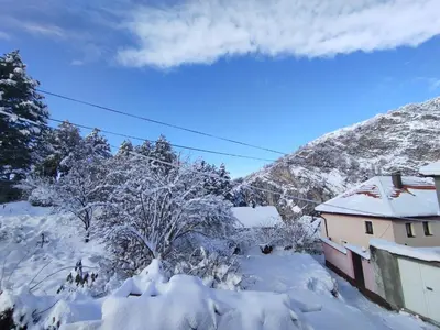 a house covered in snow in front of a mountain at Old Town in Livno