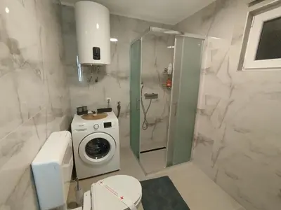 a bathroom with a washing machine and a washer at Old Town in Livno