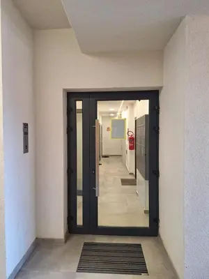 a hallway with a door in a building at Urban Cube Apartment - Tuzla City Center in Tuzla