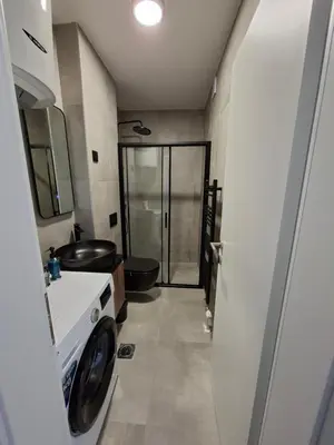 a bathroom with a toilet and a sink and a shower at Urban Cube Apartment - Tuzla City Center in Tuzla