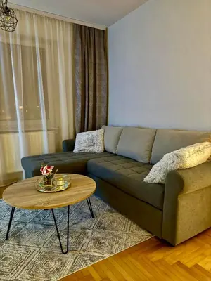 a living room with a couch and a table at Alexa Apartmani in Banja Luka