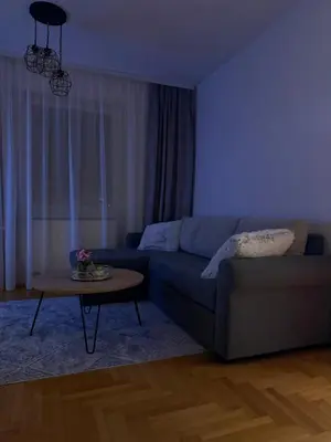 a living room with a couch and a table at Alexa Apartmani in Banja Luka