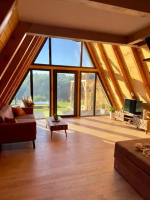 a living room with a roof with large windows at Harmony cottage in Banja Luka