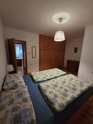 a bedroom with two beds and a chandelier at Apartment SOFI Novi Travnik in Novi Travnik