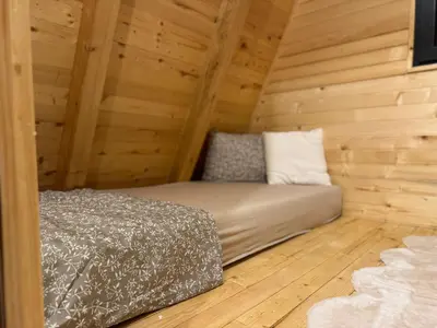 a bedroom with a bed in a wooden cabin at Soul Rest in Visoko