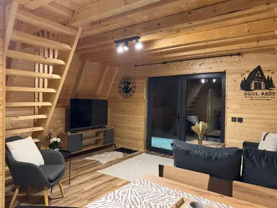 a living room with a couch and a television at Soul Rest in Visoko