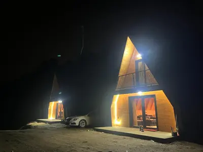 a car parked in front of a building at night at Soul Rest in Visoko