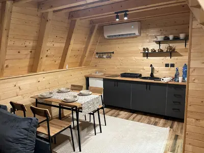 a kitchen with a table with chairs and a counter at Soul Rest in Visoko