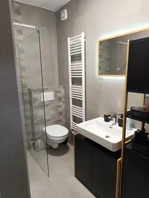 a bathroom with a toilet and a sink and a mirror at Apartman Home Away in Banja Luka