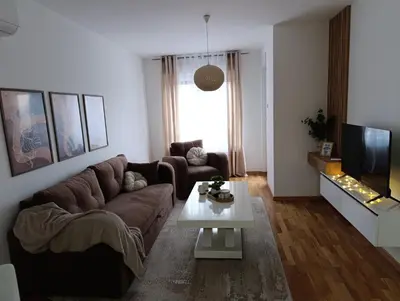 a living room with a couch and a coffee table at Apartman Home Away in Banja Luka