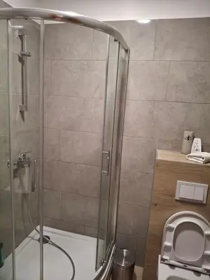 a shower stall in a bathroom with a toilet at Koncept RK in Banja Luka