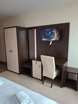 a bedroom with a bed and a desk and a chair at Koncept RK in Banja Luka