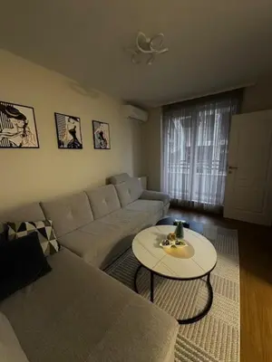 a living room with a couch and a table at Apartman ARENA 2 Doboj in Doboj