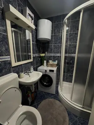 a bathroom with a shower and a toilet and a sink at Apartman ARENA 2 Doboj in Doboj