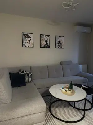 a living room with a couch and a table at Apartman ARENA 2 Doboj in Doboj