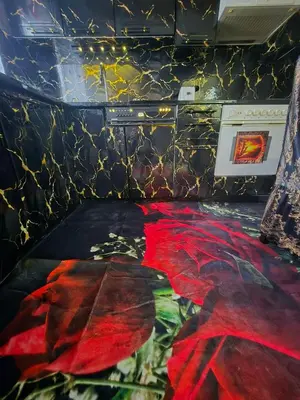 a room with a table with a red blanket on the floor at KONAK kod ODISEJE 3 in Tuzla