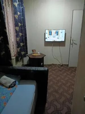 a living room with a couch and a flat screen tv at KONAK kod ODISEJE 3 in Tuzla