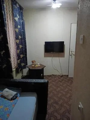 a hotel room with a couch and a tv at KONAK kod ODISEJE 3 in Tuzla