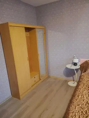 a room with a mirror and a bed and a table at KONAK kod ODISEJE 3 in Tuzla