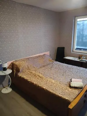 a large bed in a room with a window at KONAK kod ODISEJE 3 in Tuzla