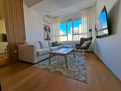 a living room with a couch and a table at Olive NOOK in Banja Luka