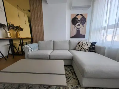 a living room with a couch and a table at Olive NOOK in Banja Luka