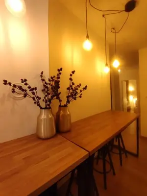 two vases with flowers in them on a wooden table at Olive NOOK in Banja Luka