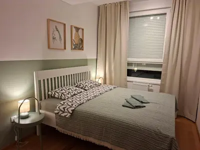 a bedroom with a bed and a window with at Olive NOOK in Banja Luka