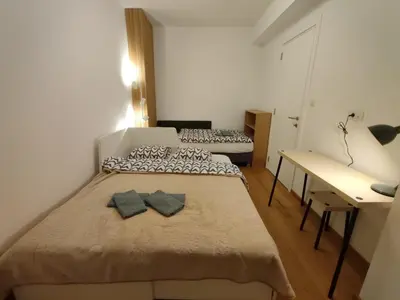 a small room with two beds and a desk at Olive NOOK in Banja Luka